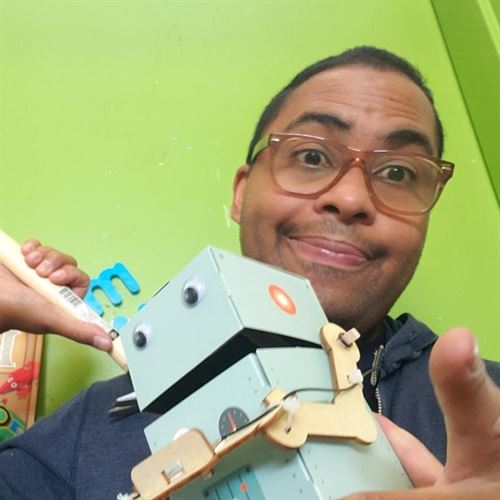 Man with cardboard robot creation